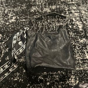 Black skull purse with cute scarf.